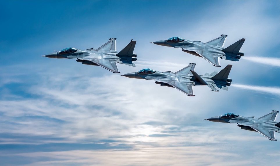 Four fighter jets flying in formation.